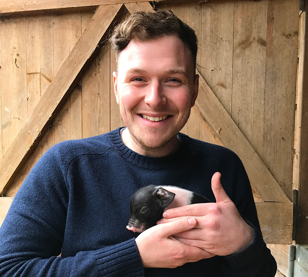 Jamie with a piglet, 2017
